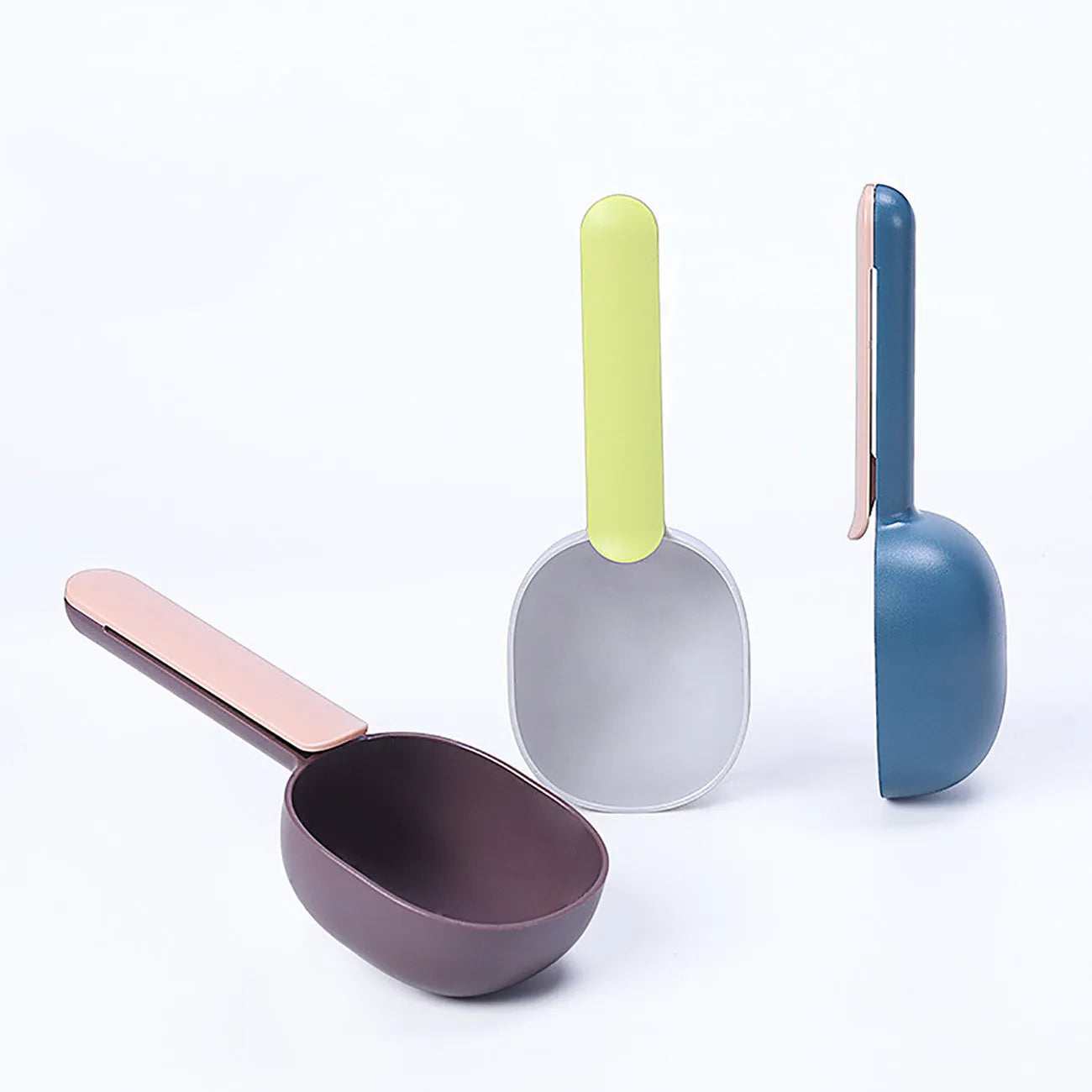 Blue plastic pet food scoop with ergonomic handle and bag clip on a white background
