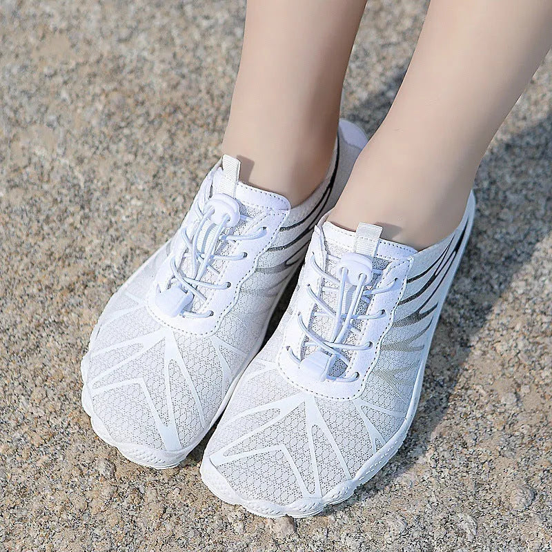 Casual low-top running shoes in black and white colourway with front lace-up closure.