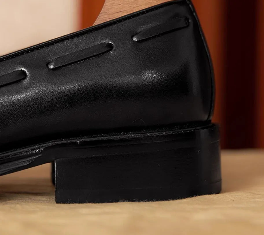 Men's black and brown genuine leather slip-on loafers with a fringed detail and rubber sole.