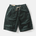 Man wearing retro khaki cargo shorts with a straight leg and street style design.