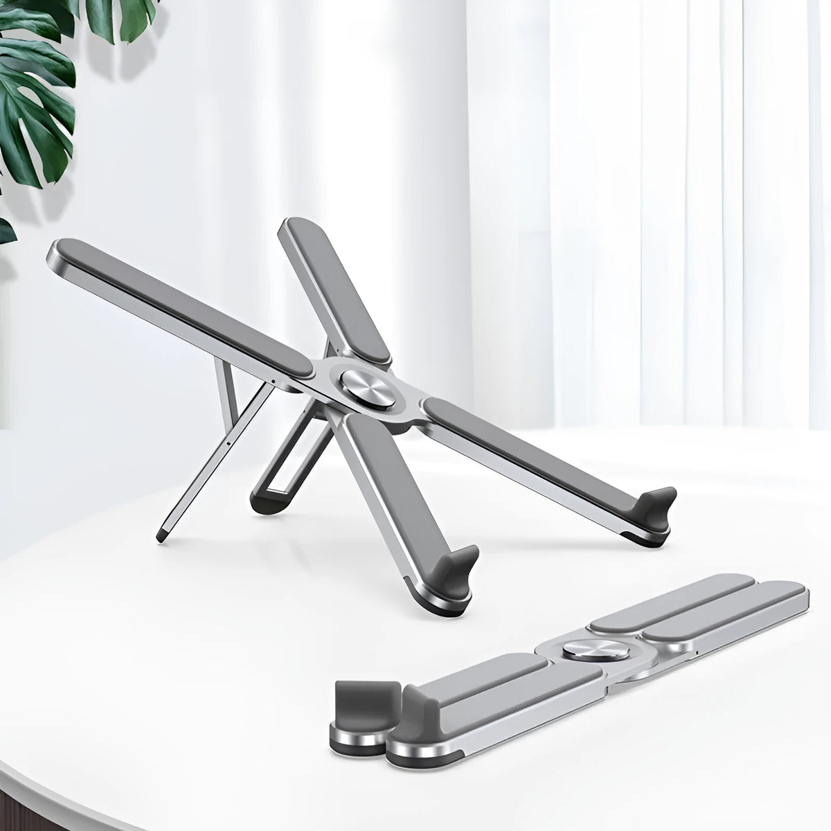 Foldable aluminium alloy laptop stand in silver or black, folded size 280mm x 23.5mm x 46.5mm