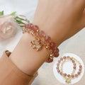 Retro style women's bracelet with colour hair crystal or strawberry quartz beads on a wrist.