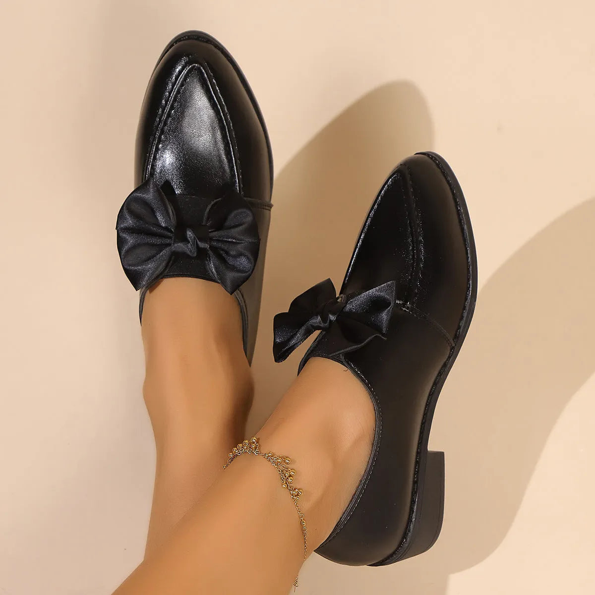 Women's simple leather shoes with a choice of large buckle bow or small bowknot decoration, pointed toe, and rubber sole.