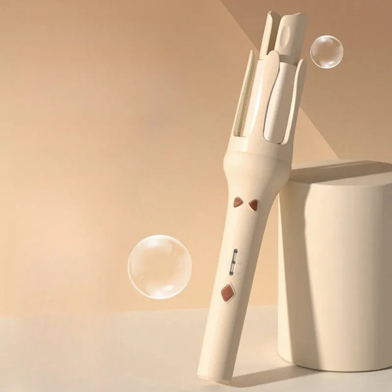 White and pink automatic hair curler with a 32mm ceramic barrel and a US plug adapter on a table.
