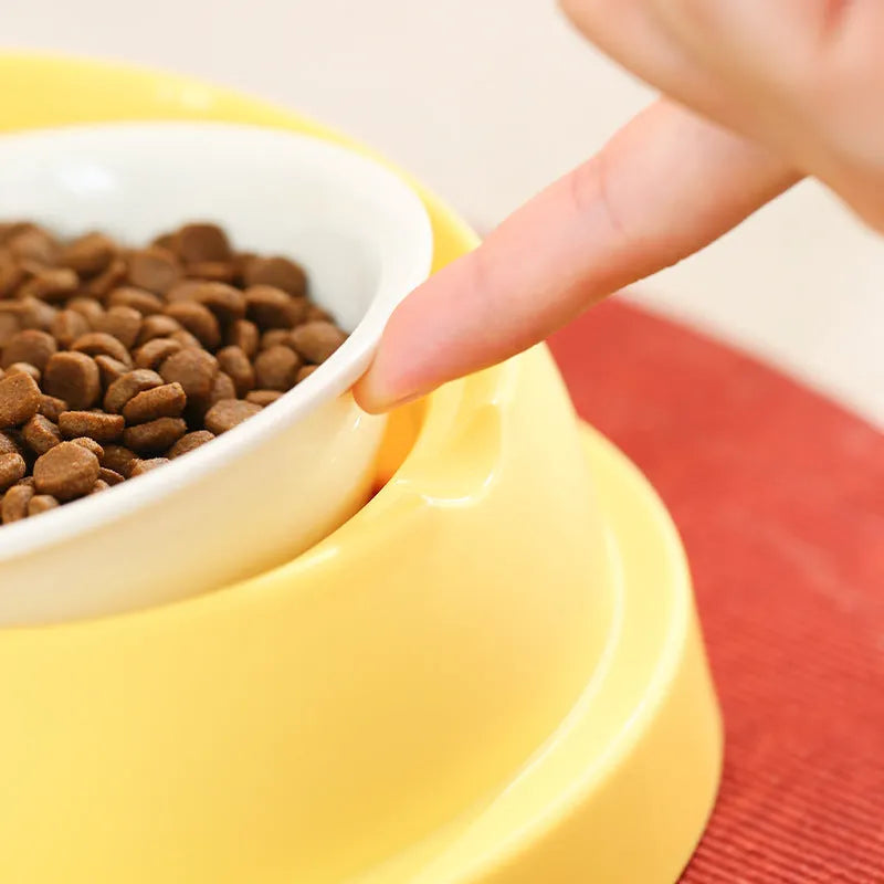Grey and yellow double pet feeding bowl with ceramic food bowls and stainless steel water dish on a PP plastic base.