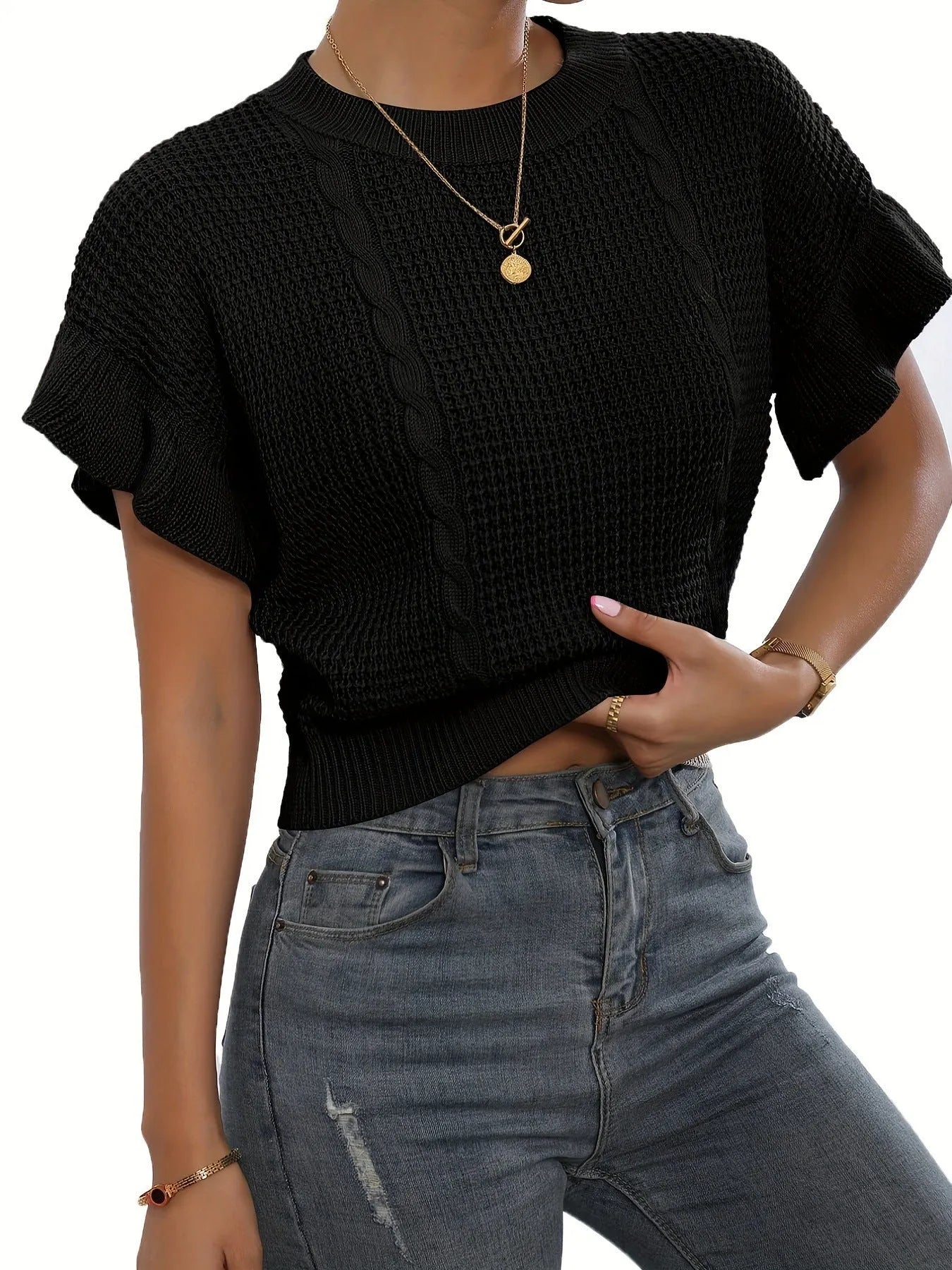 Knitted loose pullover sweater with ruffled short sleeves and a 3D twisted string pattern, shown in a neutral colour.