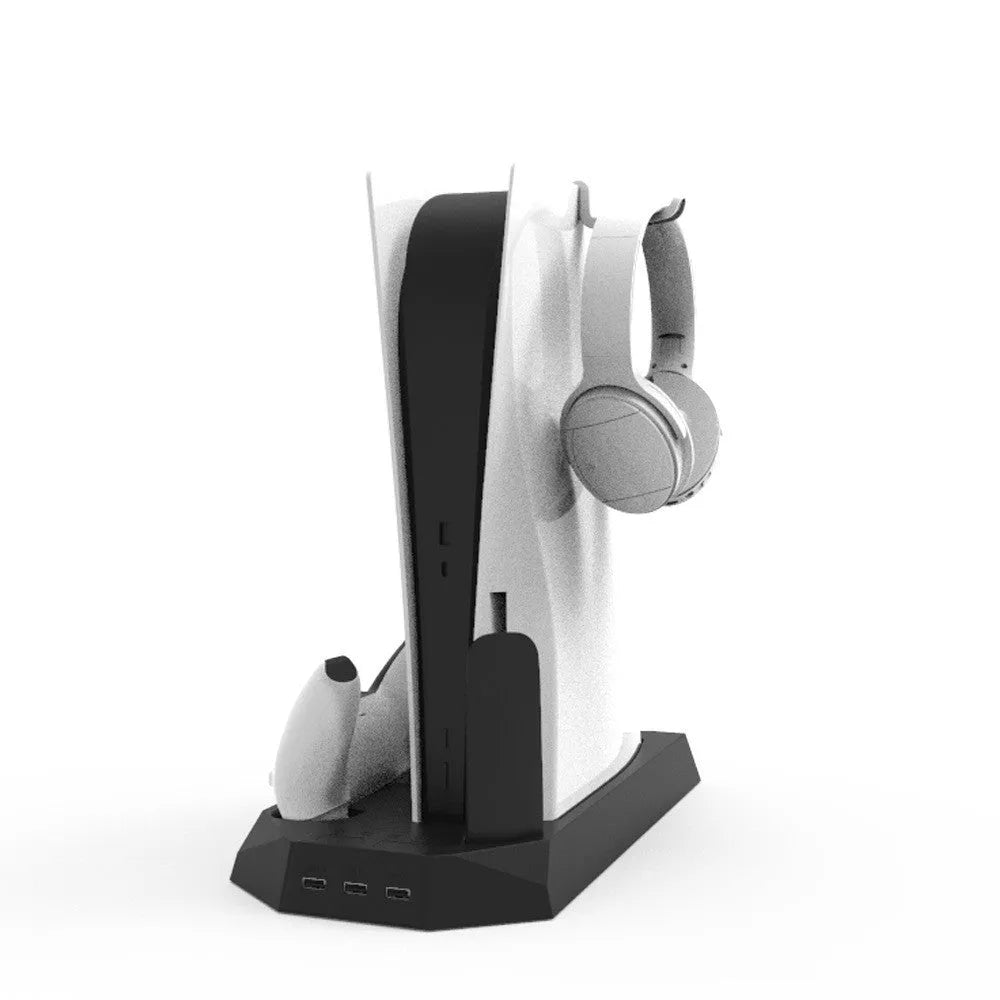 White PS5 charging base and radiator stand holding console, controllers, remote, and headset