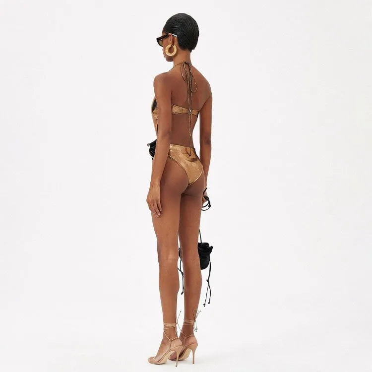 Gold halter one-piece swimsuit with hollow out design on mannequin