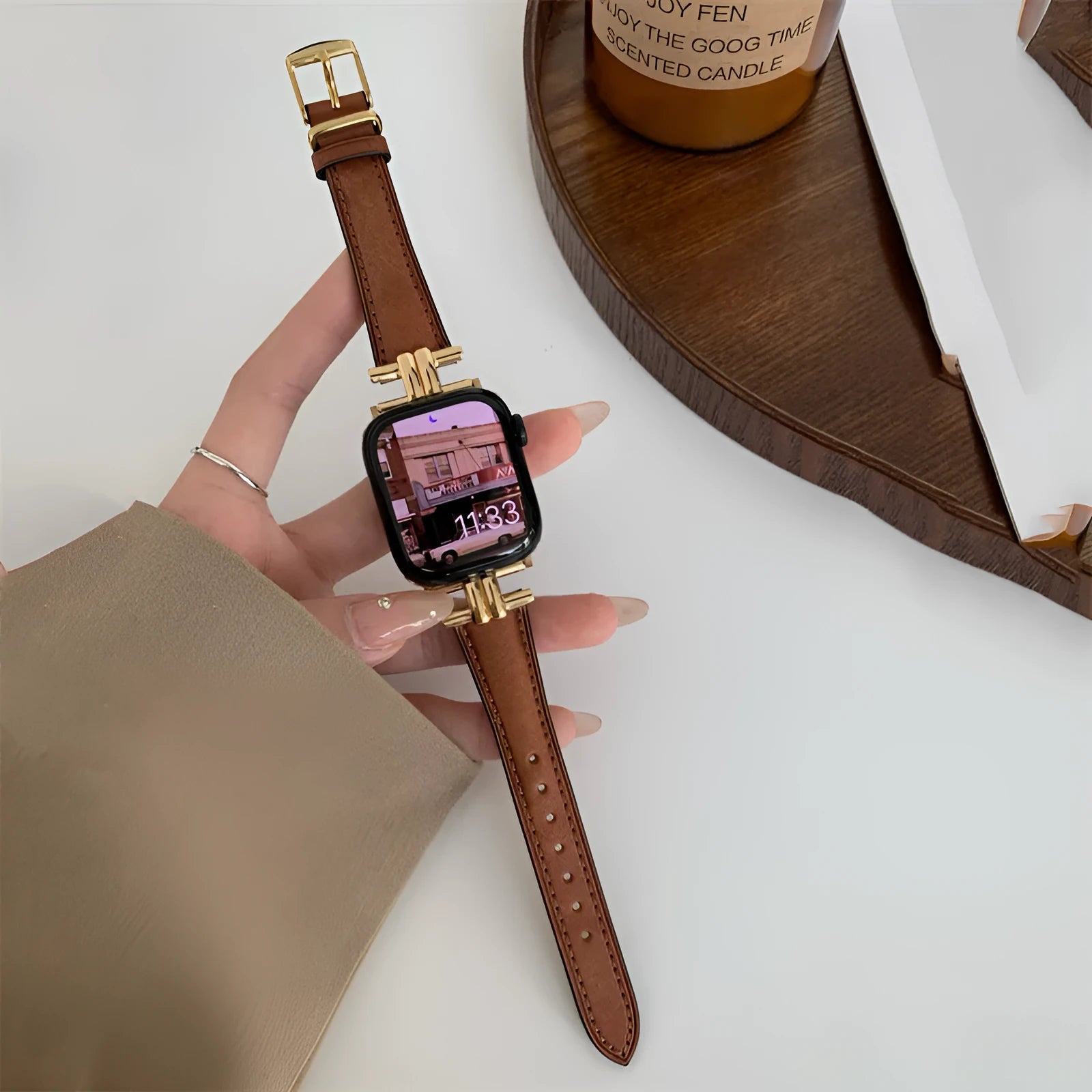 Genuine leather Apple Watch strap with metal stitching in brown colour on a dark background