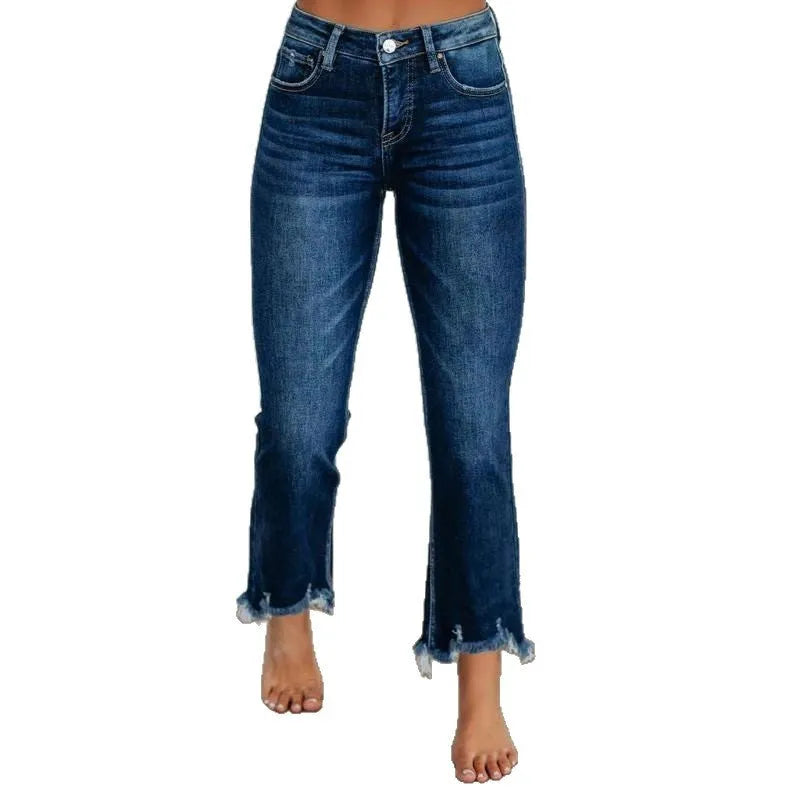 A pair of women's solid colour denim trousers with a manual wear finish, shown in dark blue.