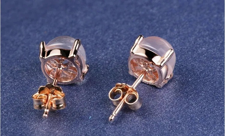 Rose gold drop shape stud earrings with crystal inlay detail on a silver base.
