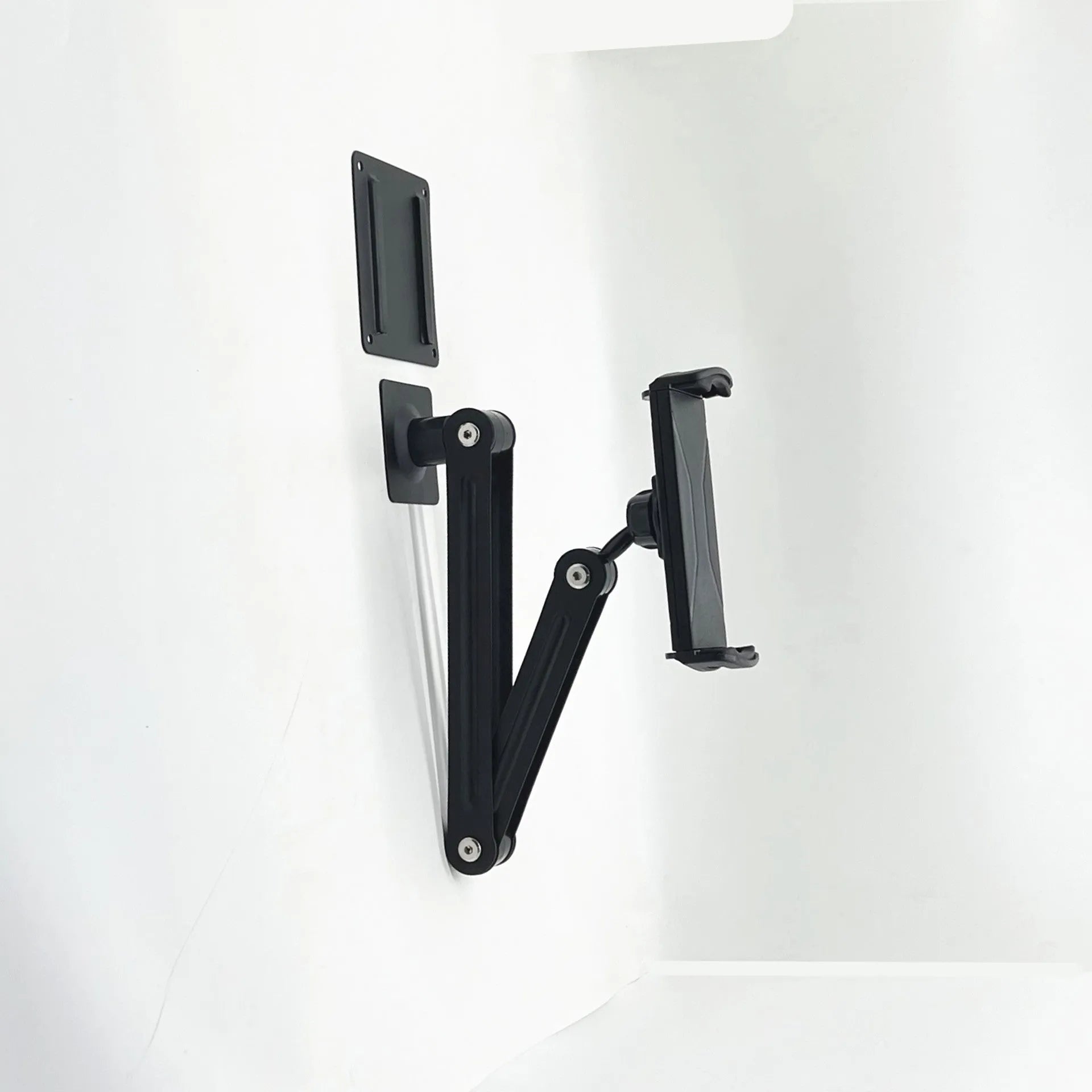 Universal alloy wall rack holding a tablet and a large mobile phone in vertical orientation