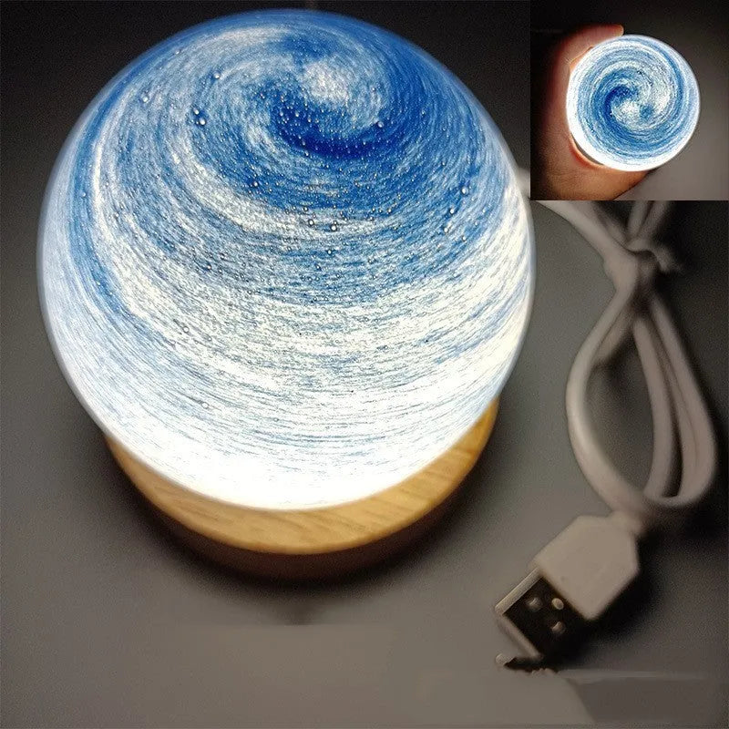 Modern planet-shaped USB night light on its base with dimmable multi-colour glow