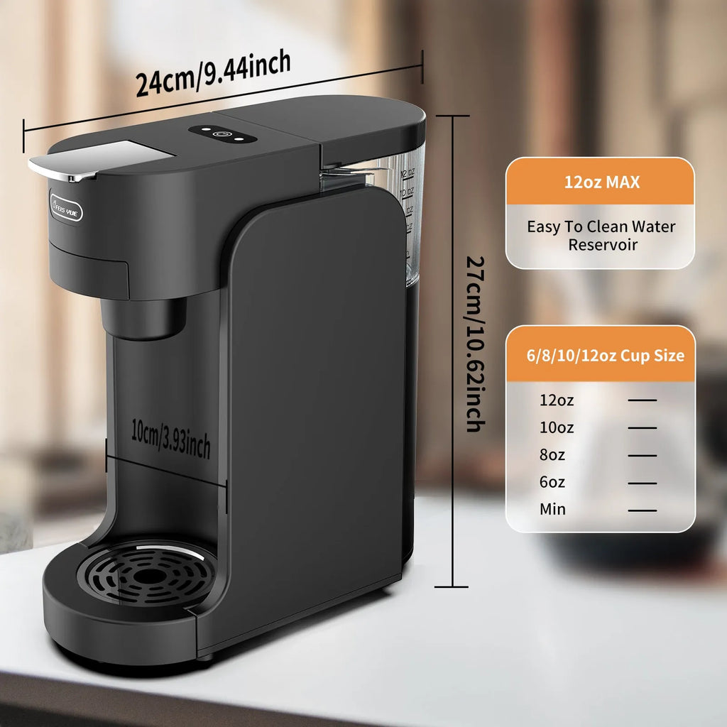 Black and white mini capsule coffee machine with transparent water tank and stainless steel drip tray on a kitchen counter
