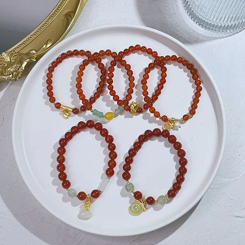Handcrafted red agate bracelet for women with Chinese dragon design and lucky charm variations