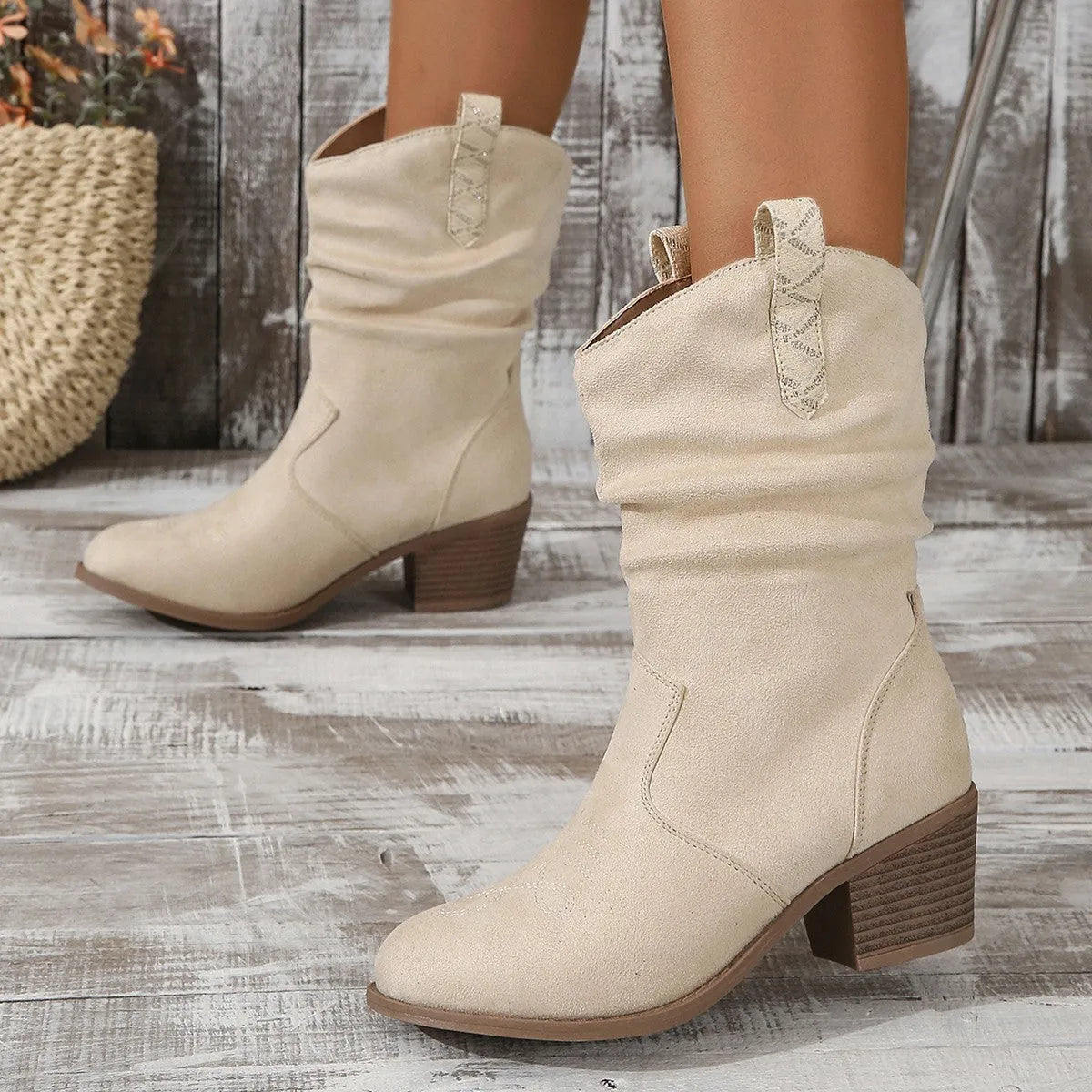 Women's mid-calf suede boots with leather stitching and a short stout heel, shown in lotus root colour.
