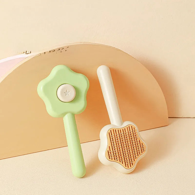 Green self-cleaning cat grooming comb with stainless steel needles and wand handle