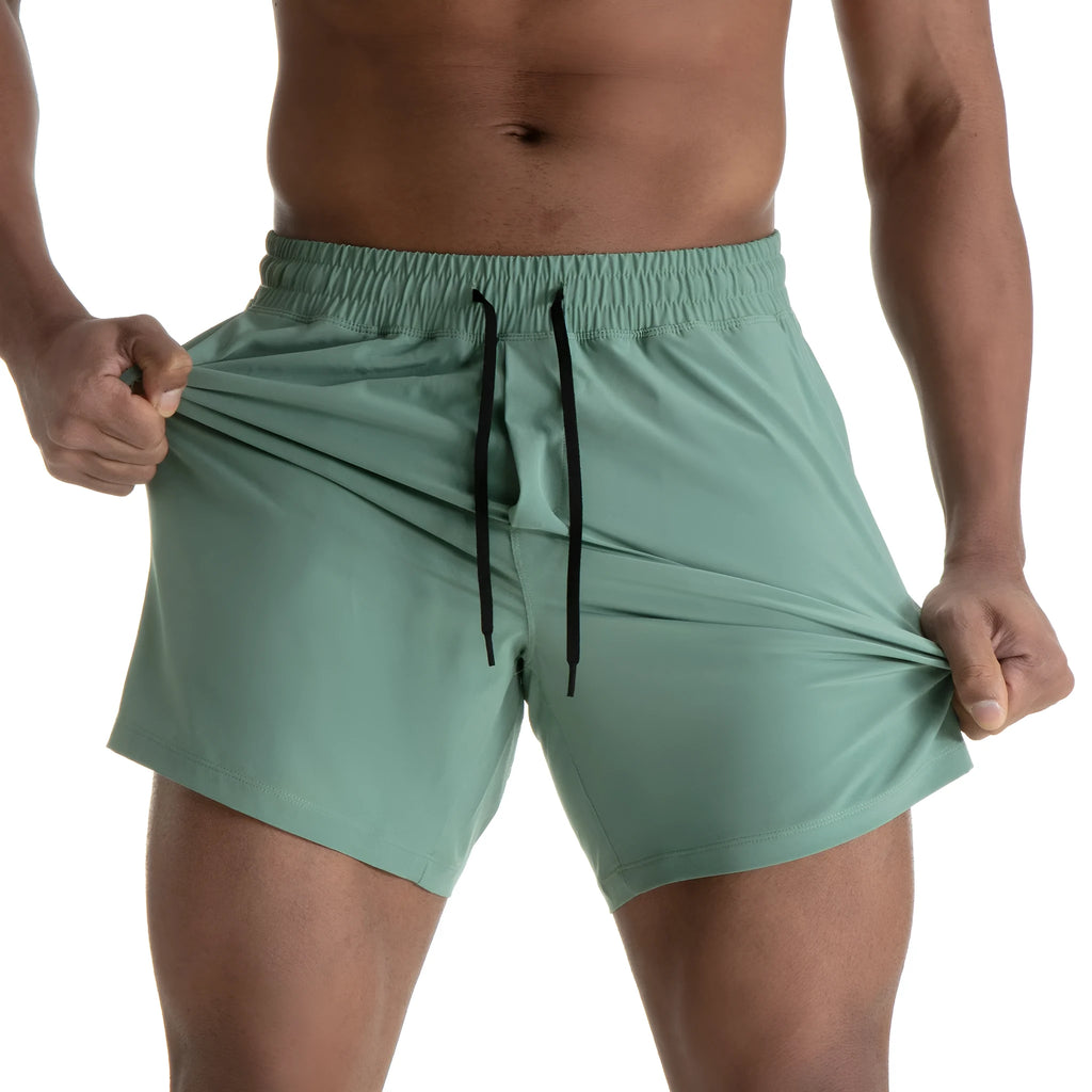 Men's black quick-drying sports shorts with mesh stitching detail on a grey background.
