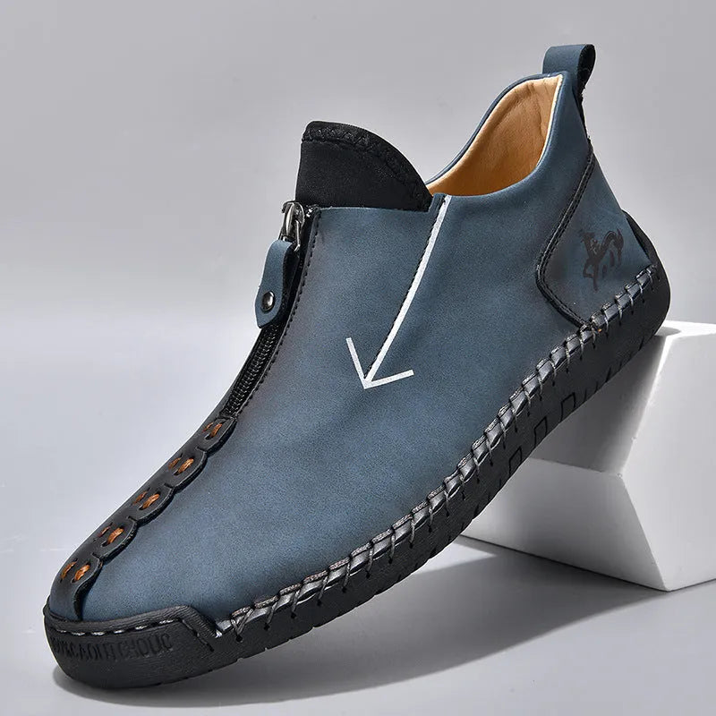 Men's black leather casual boot with front zip, round toe, and rubber sole on a white background.