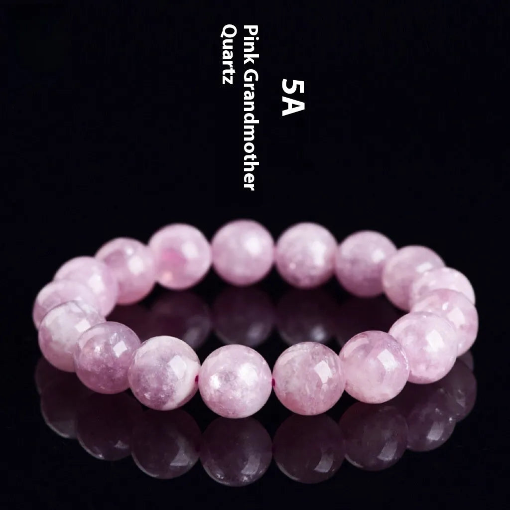 Polished purple and pink crystal grandmother bracelet with geometric beads on a wrist, showing Korean-style unisex design.