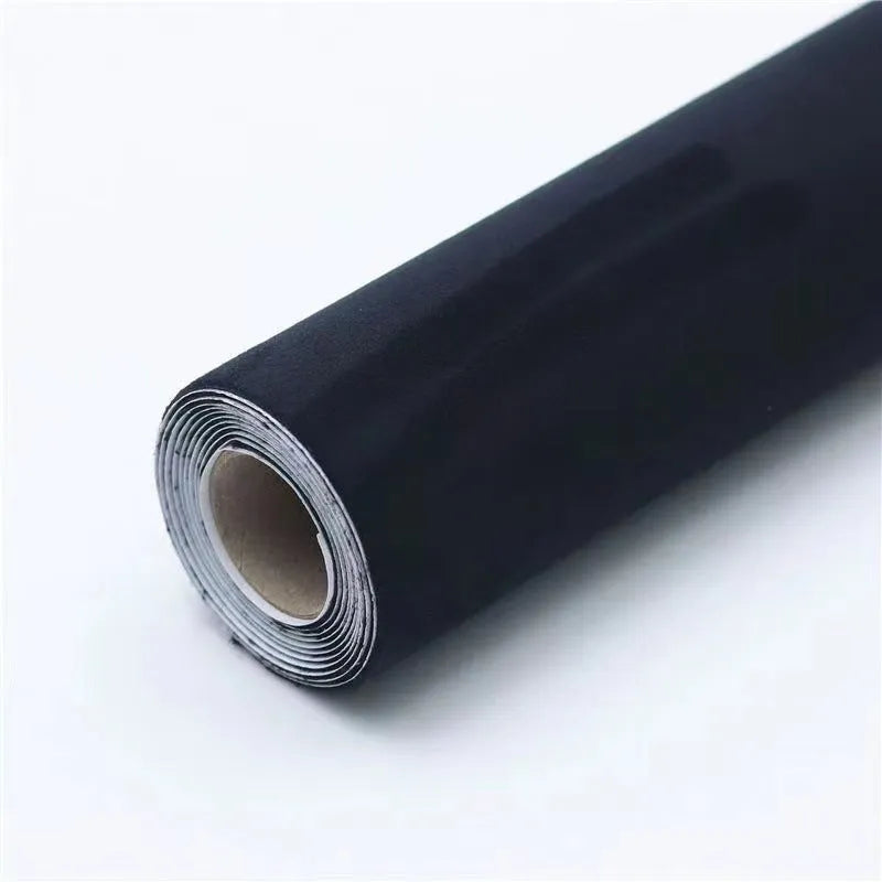 Roll of self-adhesive leather suede fabric in BMW brown colour next to a car dashboard.