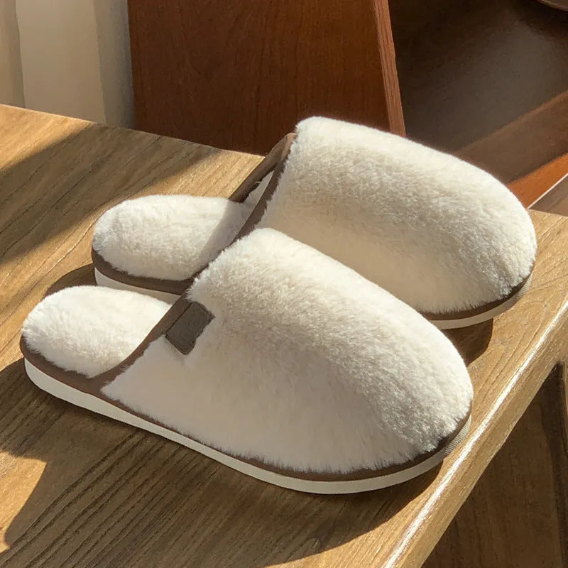 Pair of solid-colour plush PVC slippers with an overshoe design and a textured non-slip sole.