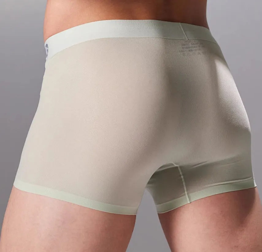 Seamless antibacterial fitness shorts in colours green, black, blue, and silver on a size chart.