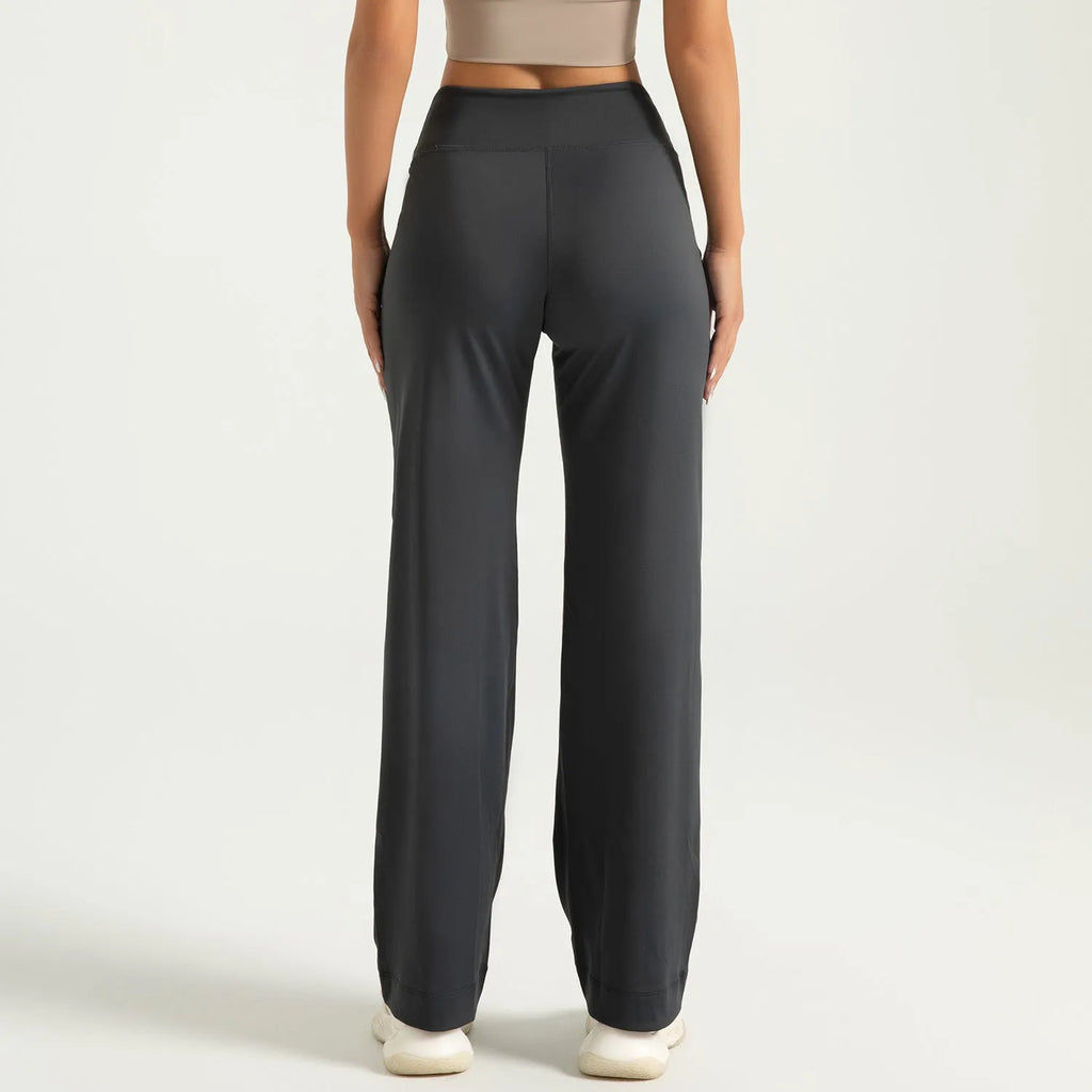 Women's high waist loose fit drawstring sports trousers in Star Black, side view, with elastic waistband and straight leg.