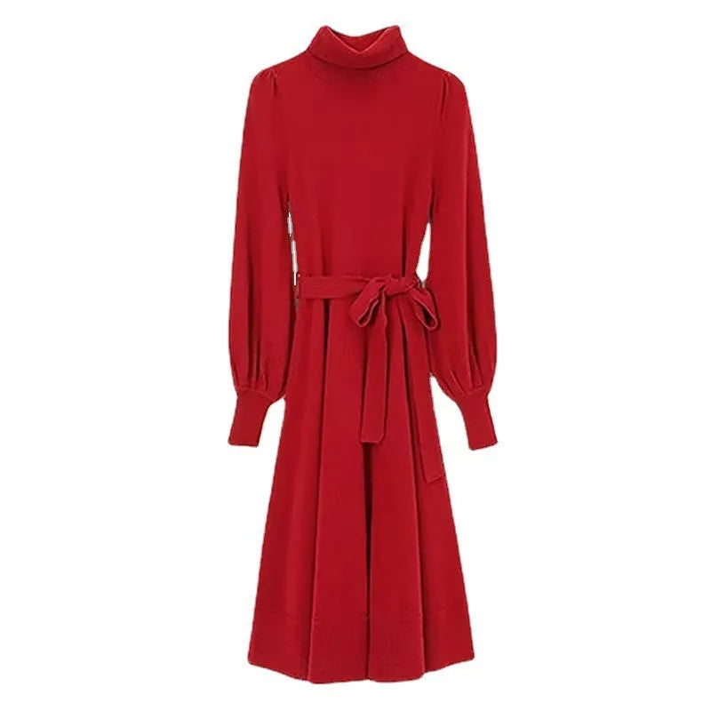 A woman wearing a rose red loose knitted turtleneck dress with a big hem midi skirt.