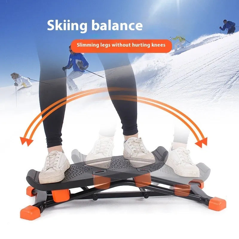 Black mini indoor fitness skiing machine with elastic hand straps on a home floor.