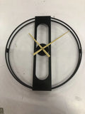 Round metal wall clock with 50cm diameter in black or gold finish on a wall
