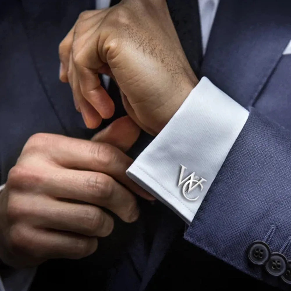 Handmade frosted personalised name abbreviation metal cufflinks in gold colour on a grey background