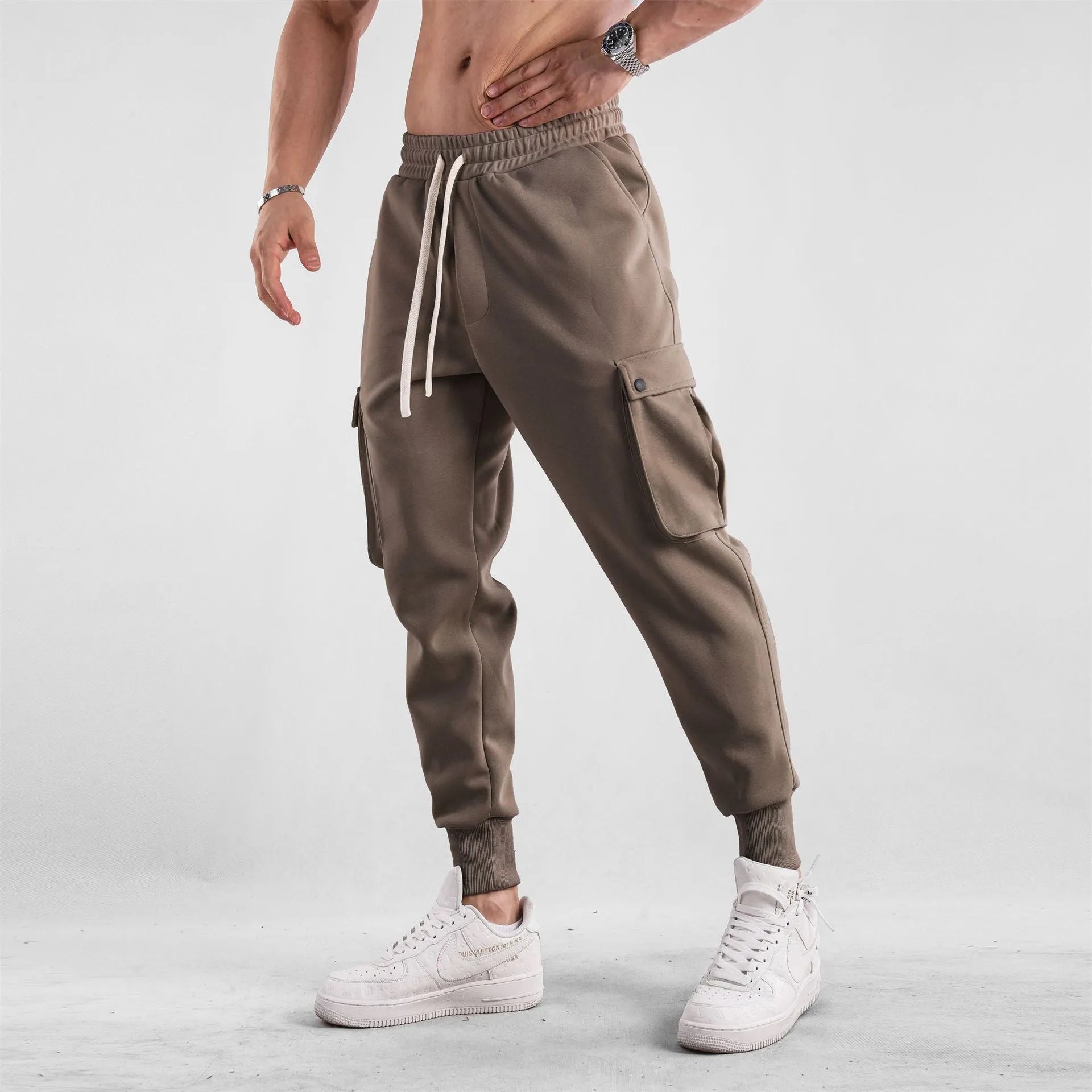 Men's loose-fit cotton sports trousers with ankle ties and multiple pockets in solid colour