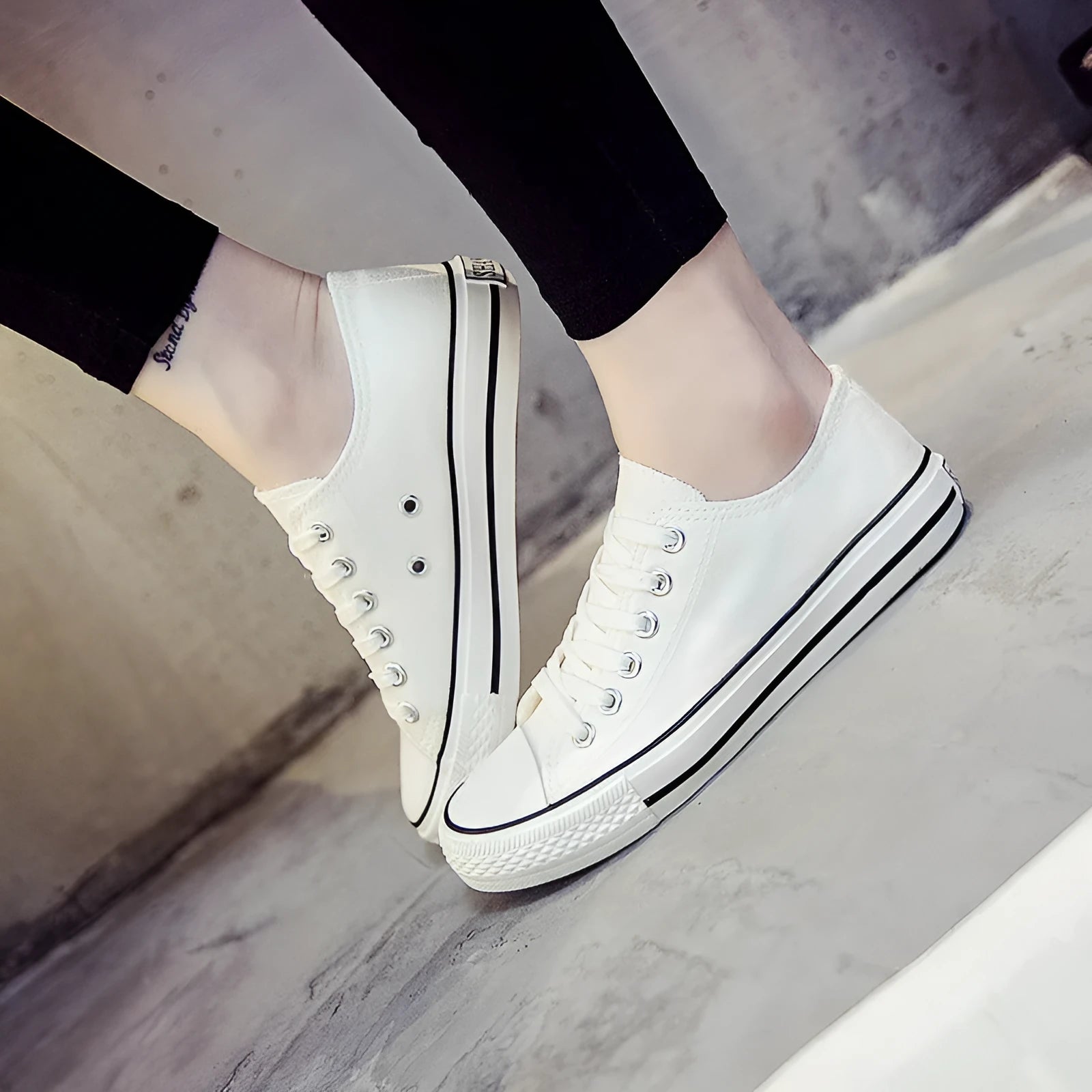 A pair of solid colour canvas lace-up trainers for women on a summer background.