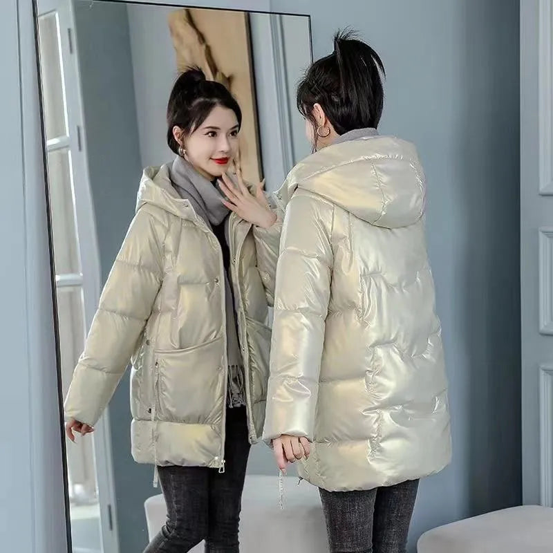 A woman wearing a green ultra-thin hooded winter jacket with long sleeves, showing the front design.