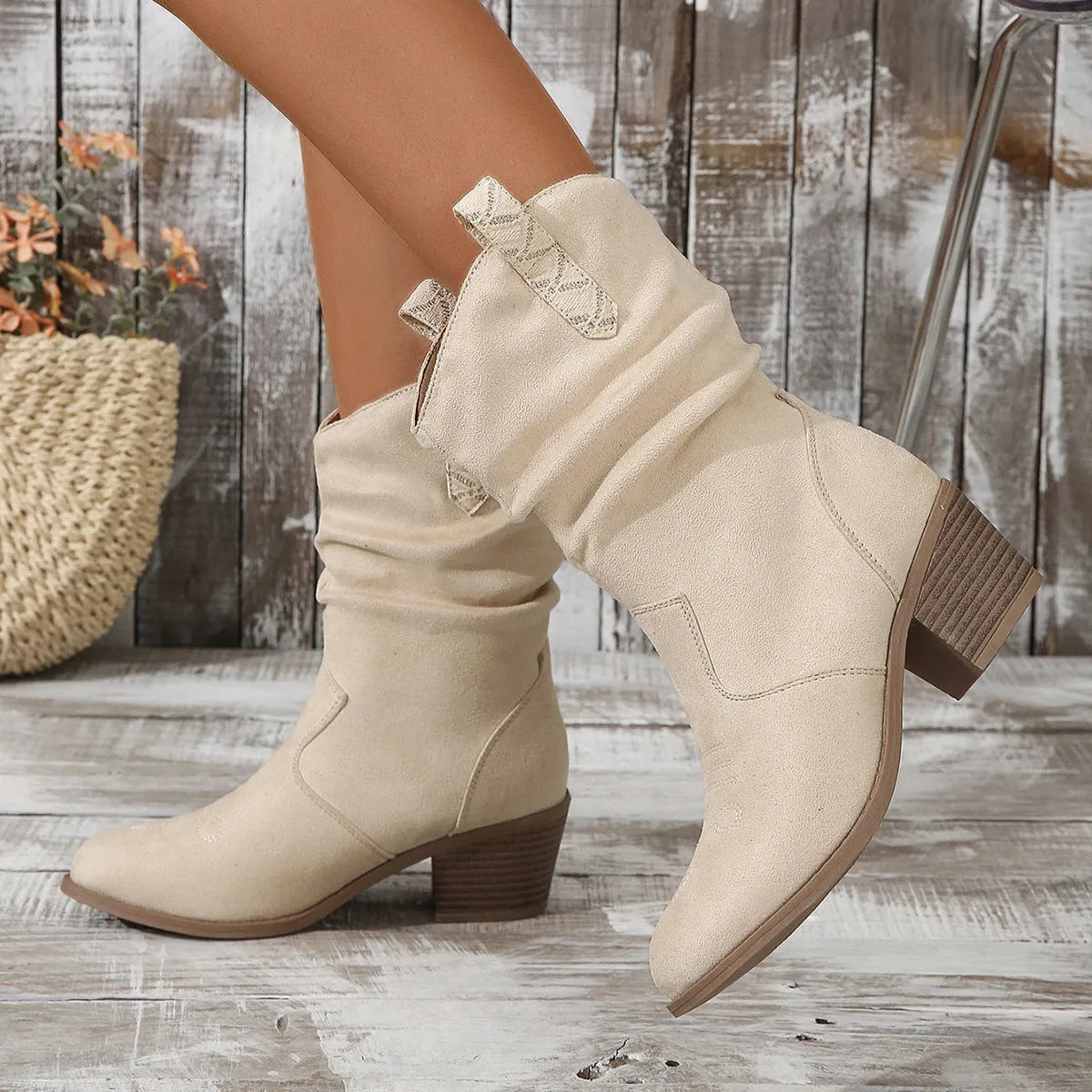 Women's mid-calf suede boots with leather stitching and a short stout heel, shown in lotus root colour.