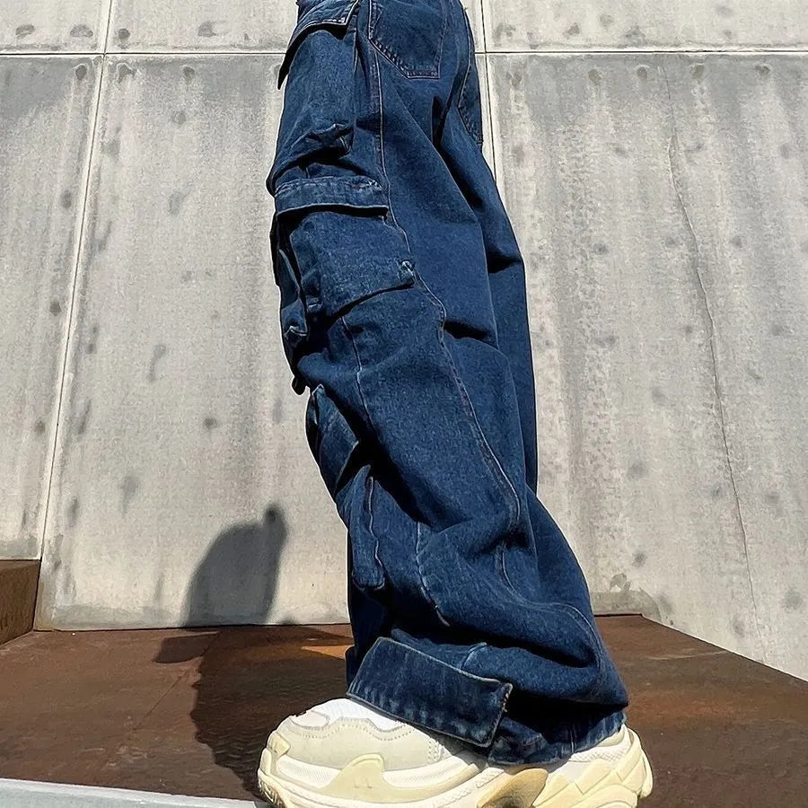 Dark blue distressed women's wide-leg jeans with a high waist and multiple pockets on a neutral background.