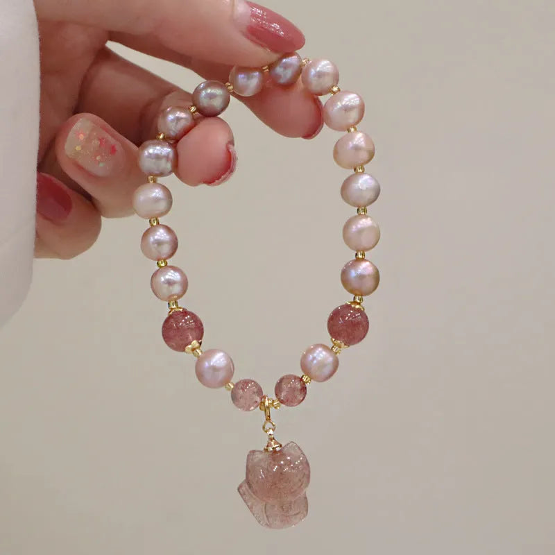 Women's light pink freshwater pearl bracelet with strawberry quartz beads and fox charm