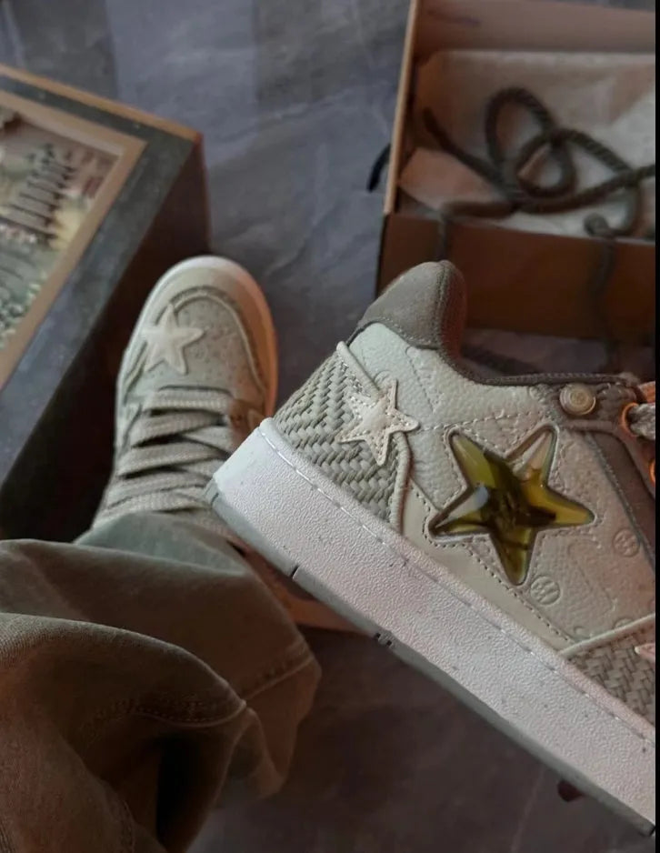 Green low-top casual sneakers with white star pattern stitching, round toe, and flat rubber sole on a white background.