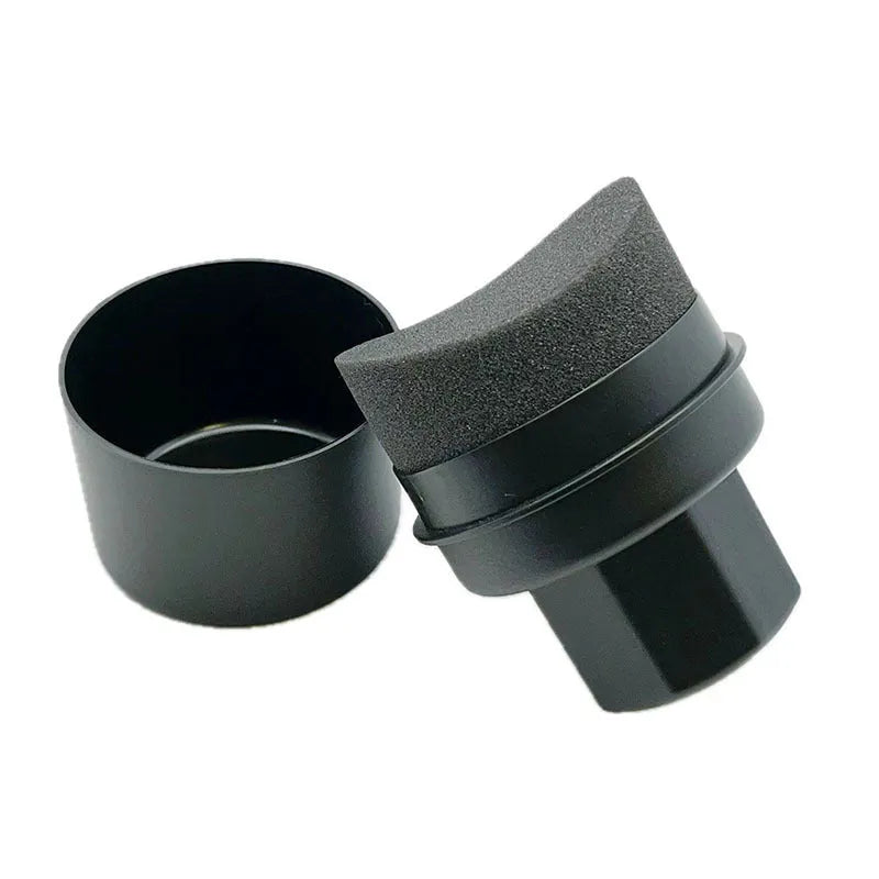 Black and red car tyre polishing sponge brushes with lids on a tyre, showing flat and curved sponge edges.