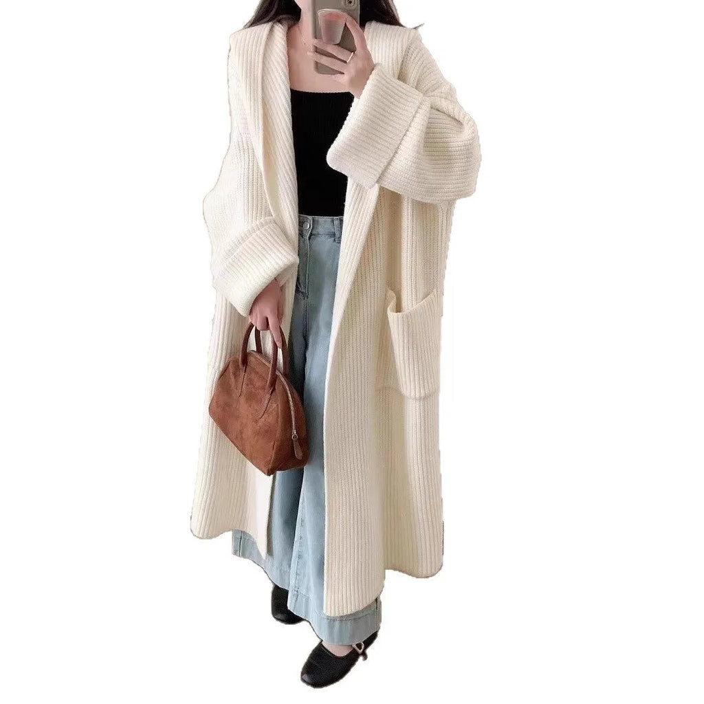 Women's loose grey hooded cardigan coat with raglan sleeves on a hanger.