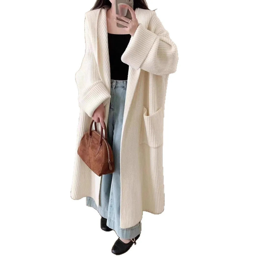 Women's loose grey hooded cardigan coat with raglan sleeves on a hanger.
