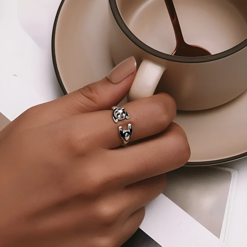 Adjustable sterling silver panda ring with white gold plating on an open band.