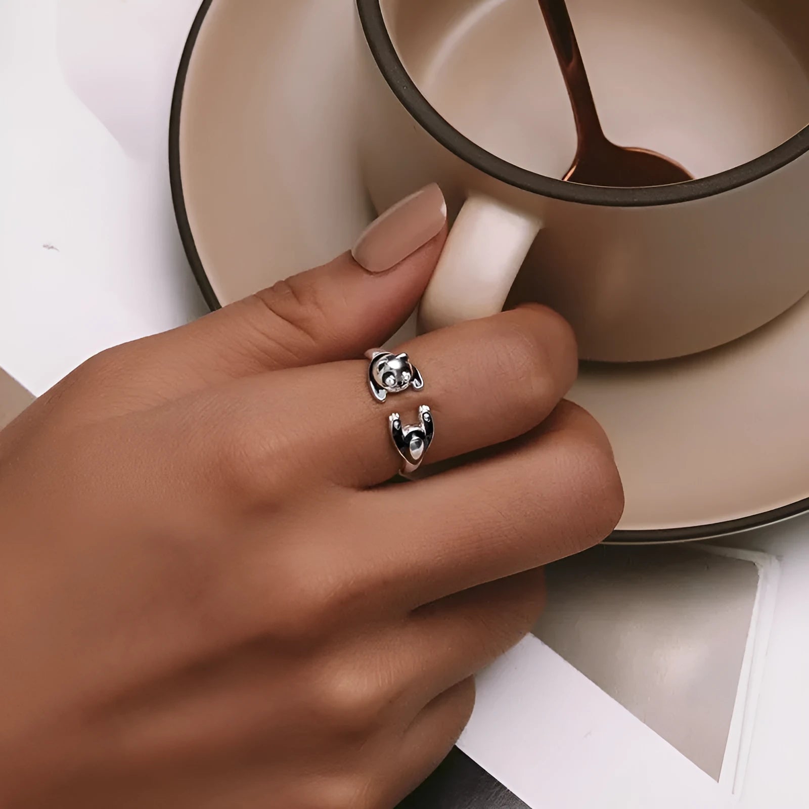 Adjustable sterling silver panda ring with white gold plating on an open band.