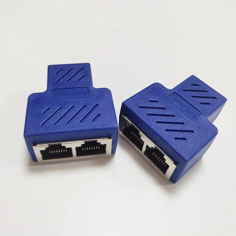 Two white RJ45 three-way tee network cable splitters on a surface