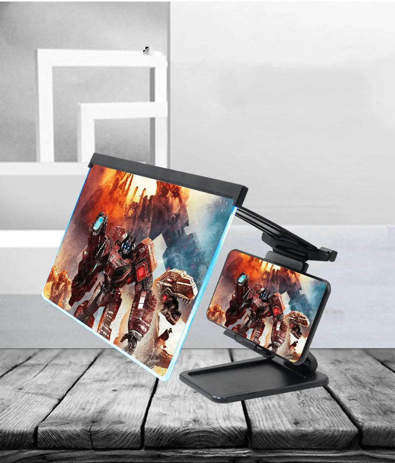 Black foldable mobile phone screen magnifier with detachable phone holder shown on a desktop.