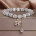 White cat's eye crystal bracelet with floral tassel and morganite safety buckle