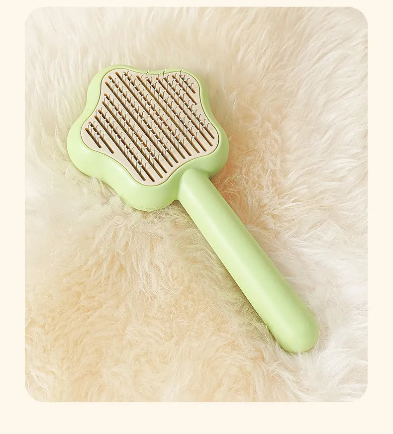 Green self-cleaning cat grooming comb with stainless steel needles and wand handle