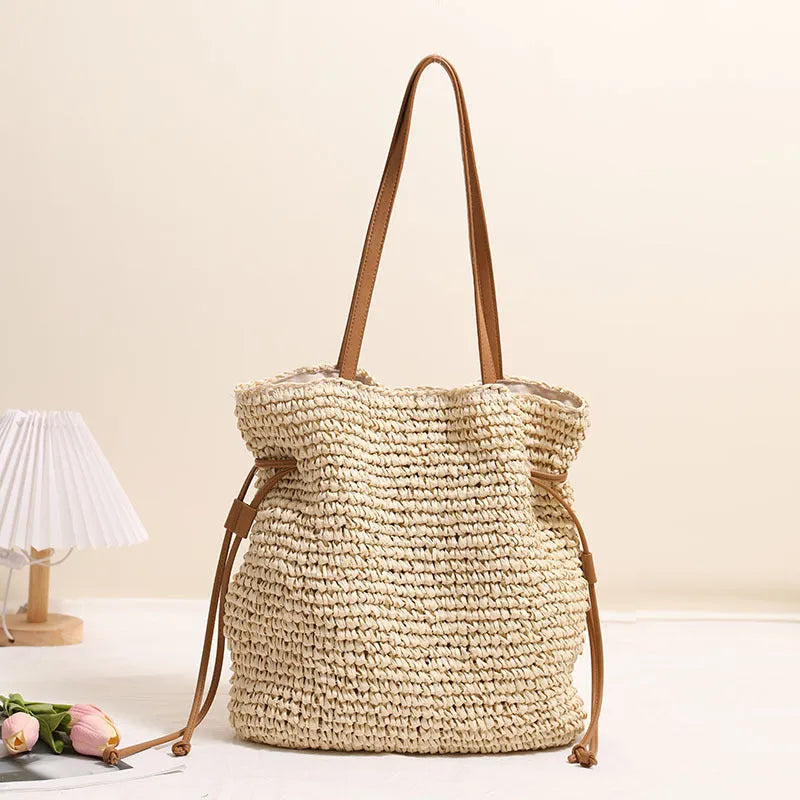 Large straw drawstring shoulder bag with polyester lining and mobile phone pocket in beige or coffee