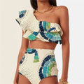 White women's one-shoulder bikini with a large lotus leaf design and split front.